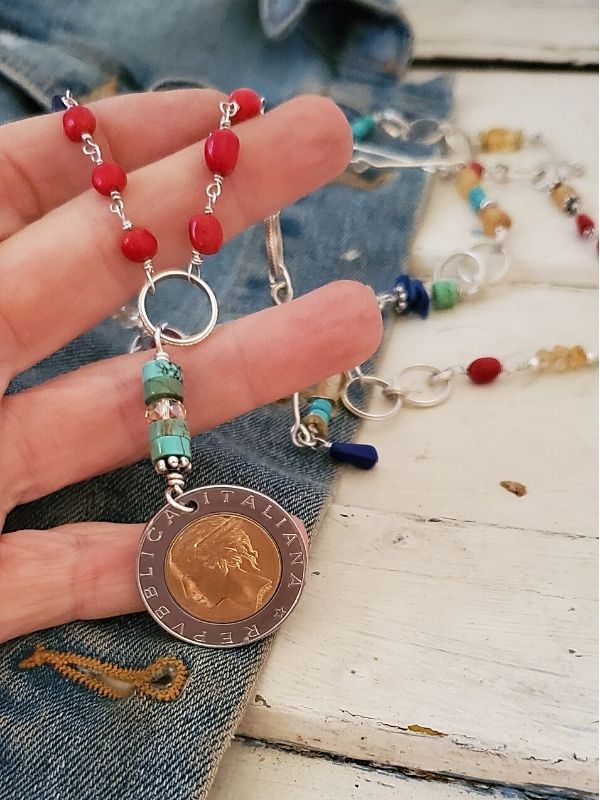 holding a gemstone Italian coin necklace